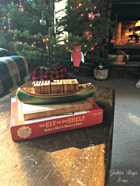 Elf on the Shelf memory game and canoe with dominos in cabin decorated for Christmas - www.goldenboysandme.com