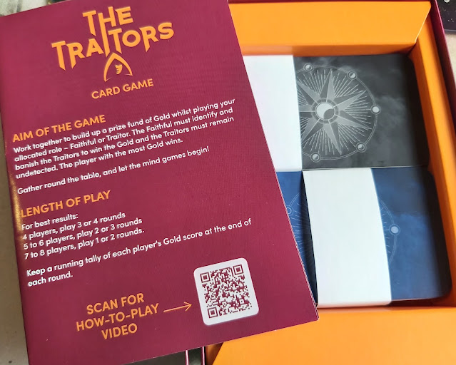 The Traitors Card Game box contents shows instruction leaflet and 2 piles of cards