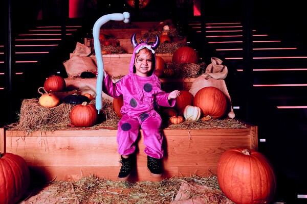 costumed child in halloween backdrop