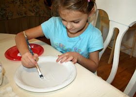 Tessa began her "Quick and Sweet Ziggurat" by arranging the bottom layer of sugar cubes on a disposable plate, drawing about its perimeter, removing the cubes, then painting with glue within the marked area. We later discovered that it is more efficient to simply dip the sugar cubes into a puddle of glue.