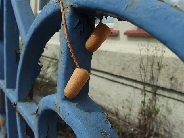 Ear plugs carefully wrapped around the railings