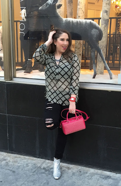 The High Heeled Brunette, Marisa Stewart shows how to get a pop of color by wearing a pink studded Saint Laurent bag and a red La Mer Collections watch