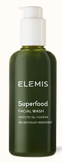 The Elemis Superfood Facial Wash captured in a green squeeze tube with white and green text, positioned against a pure, white background, emphasizing the product's natural ingredients.