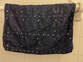 Dark blue wet pillowcase hanging on towel rod