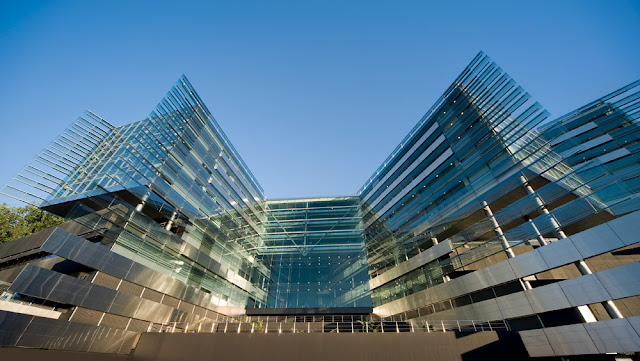 Standing in front of the modern building 