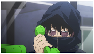 Dabi making a phone call. The heavily burned and scarred man is covered head to toe in a black rain coat, but his scarred eyes are visible,