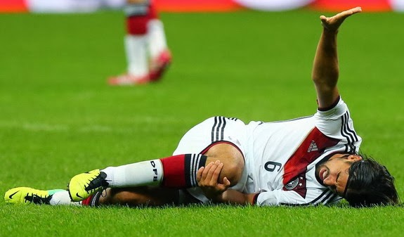 Germany player Sami Khedira reacts after being injured during a match against Italy