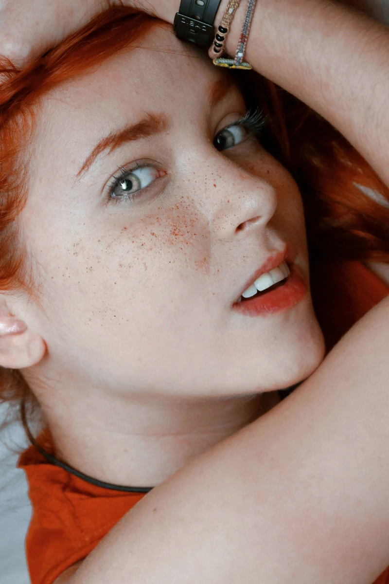 a portrait of a woman with freckles on her face