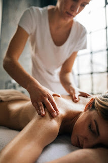 Lady massaging a woman