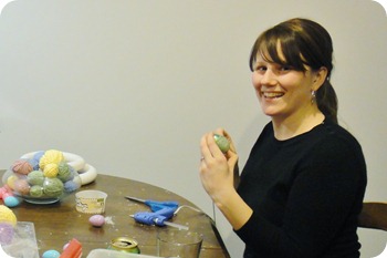 Having fun wrapping eggs.