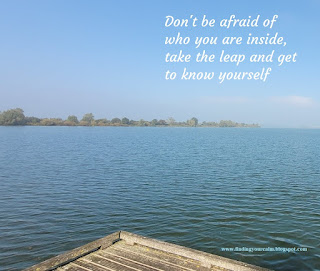 Image of a corner of a jetty looking out over a large lake with a blue sky above, with the text, Don't be afraid of who you are inside, take the leap and get to know yourself