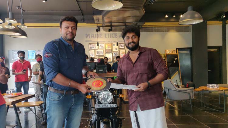Dhyan Sreenivasan taking delivery of the Limited 120 years Anniversary Edition Interceptor 650