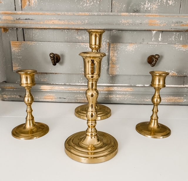 four brass candlesticks mantel decor