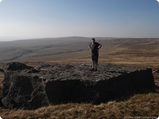 brian on a cup-marked rock