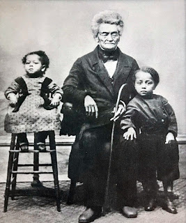 Hamilton Elzie Waters seated in the middle with two unidentified children