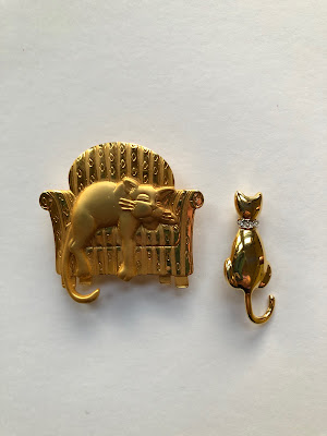 two gold cat pins