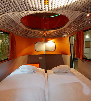  14 Crazy Hotels That Will Give You Serious Travel Goals - Caravan Hotel in Berlin, Germany is like camping for people who aren't really into experiencing the elements: It's camping quarters, but it's all indoors.