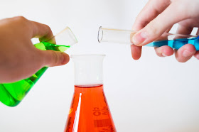 3 bottles with different coloured liquids, indicating chemicals