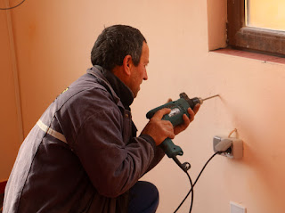 Bekir starts drilling holes to fix it in place