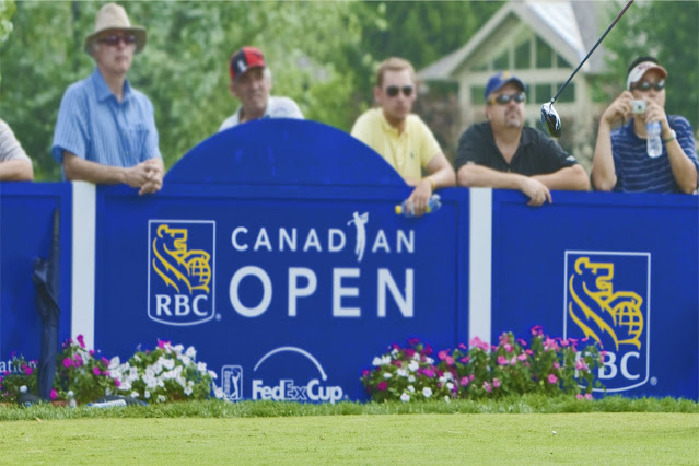 RBC Canadian Open sign on a tee box with spectators looking on