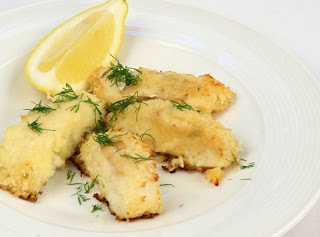  6 tablespoons butter, melted 1 tablespoon Dijon mustard 1 tablespoon lemon juice 1 tablespoon dill, chopped 1 cup Panko breadcrumbs 11⁄2 pounds codfish or other white fish fillets, cut into 3-inch strips Lemon wedges