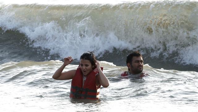 Cricketer M S Dhoni and his wife Sakshi Singh Rawat at beach