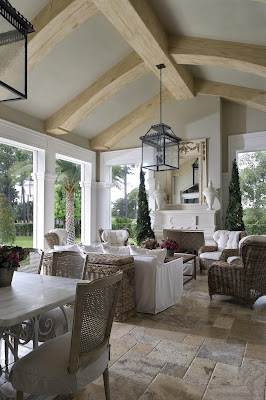 a cozy lounge and dining area open to the garden have white accent and rattan furniture