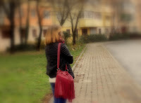 Cute, red and fluffy scarf for long walks in the city park.