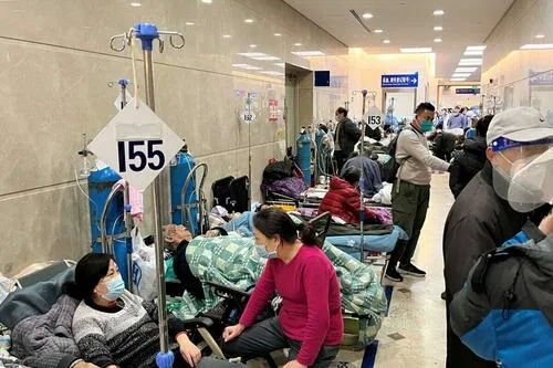 Patients lie on beds in a hallway in the emergency department of Zhongshan Hospital, amid a COVID-19 outbreak in Shanghai, China, on Jan. 3, 2023.