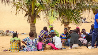 Relatives sitting at the beach and having a funeral