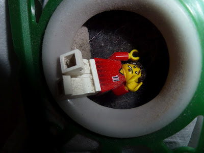 lego minifigure gets sucked up by vacuum