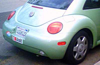 Close up of light green Volkswagen Bug  I love Judd bumper sticker visible