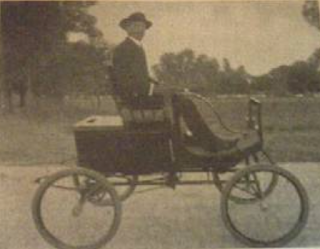 Man seated in car made in 1900