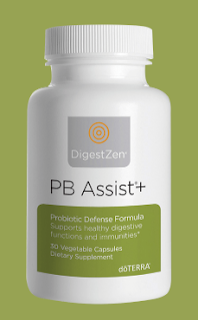 Image of doTERRA's PB Assist, a bottle of probiotic capsules. The bottle is dark blue with a label displaying the doTERRA logo and the product name. It's designed to support digestive health and immune system function, placed against a simple background emphasizing the product.