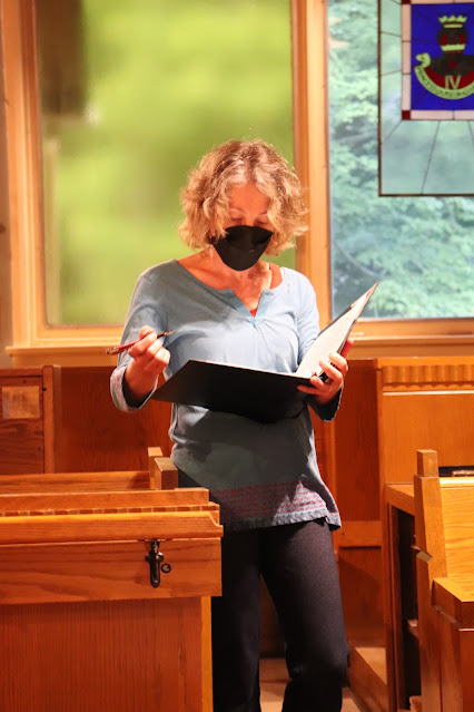 Anita making notes at choir rehearsal