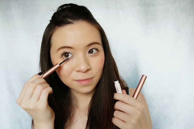Girl applying glitter eyeliner