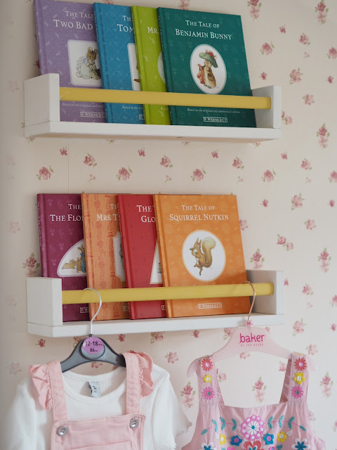 A pink and mustard yellow girls nursery bedroom, complete with cute accessories, colourful decor and homemade DIY touches. Including the IKEA Minnen bed, boho wall hanging, and IKEA hack dollhouse. Nursery inspiration and budget ideas.