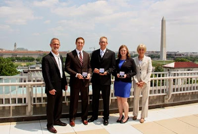 Acting Assistant Director for National Conservation Lands Tim Murphy Valor (left) and BLM Deputy Director Linda Lance (right) with award recipients Camas Beames, Eric Killoy and Mackenzie Tiegs. 