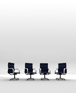 4 empty board chairs represent a need to hire consultative selling training graduates