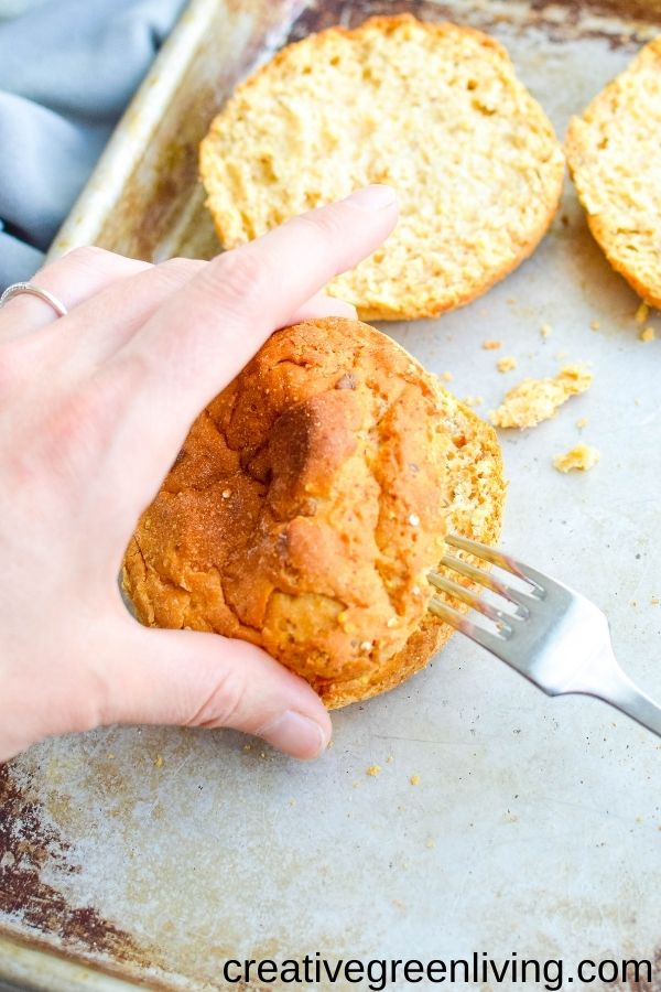 Using a fork to pop open a gluten free English muffin from Canyon Bakehouse