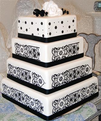 Four tier black and white damask wedding cake with dotted pattern on the top
