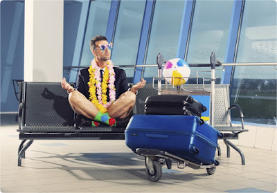 Man in a suit and shorts at Departure Lounge with suitcases