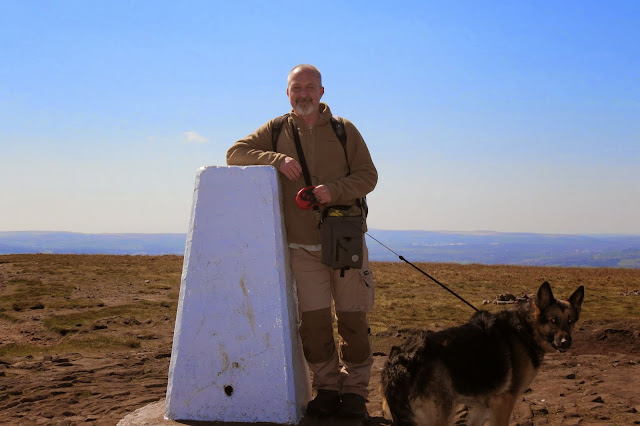 A picture of me and our German Shepherd, Lotte, by the trig column on Pendle Hill.