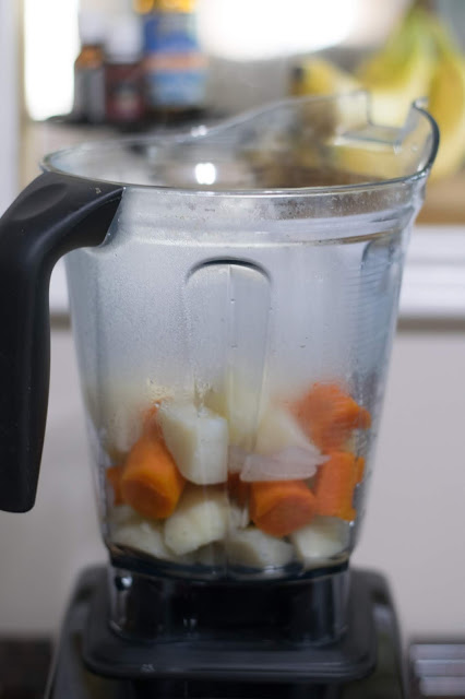 The soaked nuts and cooked vegetables in a blender. 