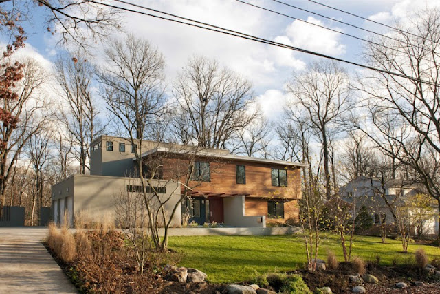 Light Brown Outer Wall Made from Wooden Material and Vast Green Grass Garden