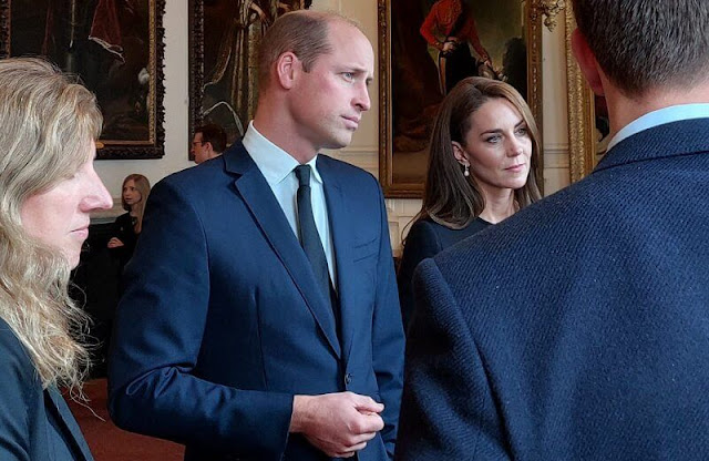 Kate Middleton wore a collarless long coat by Dolce & Gabbana. Annoushka pearl and Kiki diamond hoop earrings