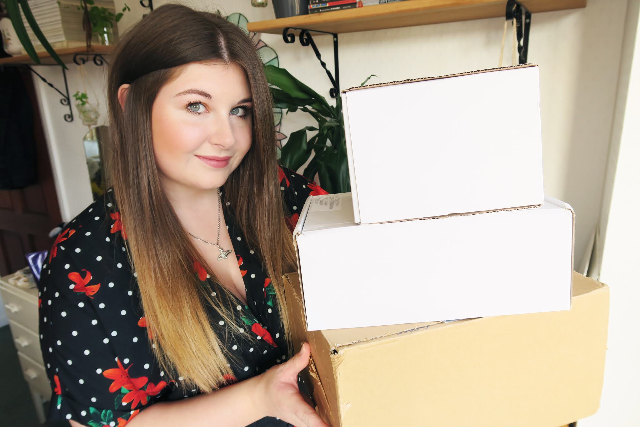 Grace is holding 3 boxes full of free PR products