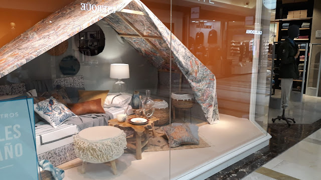 Glamping at a shopping center window dispaly