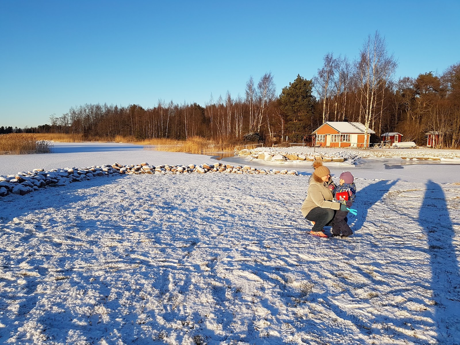mother and daughter playing in snow in Finland