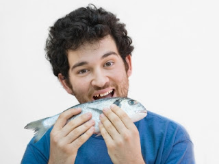 hombres comiendo pescado